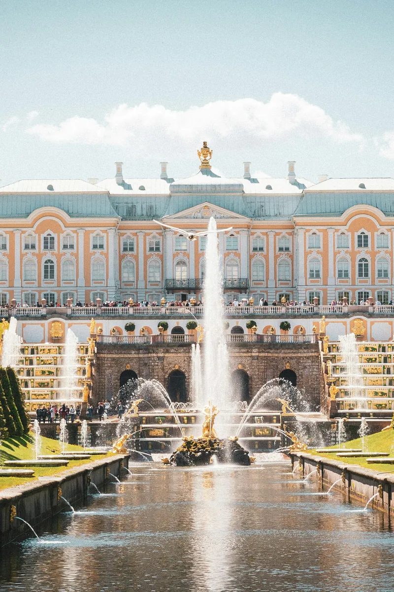 Baroque facade of the Royal Palace of La Granja de San Ildefonso reflected above its formal fountain gardens